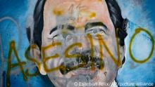 FILE - In this May 26, 2018 file photo, the Spanish word for Murderer covers a mural of Nicaragua's President Daniel Ortega, as part of anti-government protests demanding his resignation in Managua, Nicaragua. Ortega and his wife, Vice President Rosario Murillo, maintained the use of force was justified to fend off an attempted coup. Domestic and international human rights groups strongly disagreed. (AP Photo/Esteban Felix,File)