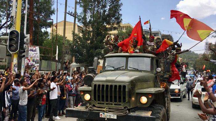 Fighters of the Tigray Defense Forces on a jeep being greeted by citizens of Mekelle