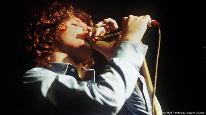 Jim Morrison sings into the microphone