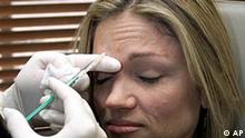 Plastic surgeon gives woman Botox injection, photo