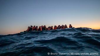 African migrants wait in a boat for help from the Spanish NGO Open Arms