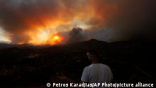 July 3, 2021***
A resident of a village watches a fire in the Larnaca mountain region on Saturday, July 3, 2021. Cyprus has asked fellow European Union member states on Saturday to help battle a huge fire in a mountainous region of the east Mediterranean island nation that has forced the evacuation of at least three villages. (AP Photo/Petros Karadjias)