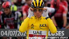 Slovenia's Tadej Pogacar, wearing the overall leader's yellow jersey, adjusts his glasses prior to the start of the ninth stage of the Tour de France cycling race over 144.9 kilometers (90 miles) with start in Cluses and finish in Tignes, France,Sunday, July 4, 2021. (AP Photo/Daniel Cole)