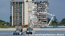 Miami-Dade County Police boats patrol in front of the partially collapsed Champlain Towers South condo building, ahead of a planned visit to the site by President Joe Biden, on Thursday, July 1, 2021, in Surfside, Fla. Rescue efforts at the site of the partially collapsed condominium building were halted Thursday out of concern about the stability of the remaining structure, officials said.(AP Photo/Mark Humphrey)