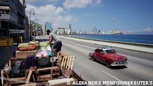 A man loads a truck with furniture to be relocated prior to the arrival of Storm Elsa, in Havana, Cuba, July 4, 2021. REUTERS/Alexandre Meneghini