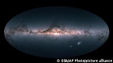 This image provided by the European Space Agency ESA, is Gaia’s all-sky view of our Milky Way Galaxy and neighboring galaxies, based on measurements of nearly 1.7 billion stars. The map shows the total brightness and colour of stars observed by the ESA satellite in each portion of the sky between July 2014 and May 2016. (ESA via AP)