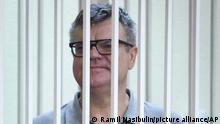 Viktor Babariko, the former head of Russia-owned Belgazprombank, stands inside a cage in a court room in Minsk, Belarus, Tuesday, July 6, 2021. The Supreme Court in Belarus has sentenced a former contender in the 2020 presidential race to 14 years in prison on corruption charges in a case that has been widely seen as politically motivated. Viktor Babariko, the former chief executive of a Russia-owned bank, aspired to challenge Belarus' authoritarian president Alexander Lukashenko in last year's election. (Ramil Nasibulin/BelTA Pool Photo via AP)