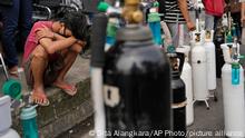 People queue up to refill their oxygen tanks at a filling station in Jakarta, Indonesia, Monday, July 5, 2021. Parts of Indonesia lack oxygen supplies as the number of critically ill COVID-19 patients who need it increases, the nation's pandemic response leader said Monday, after dozens of sick people died at a public hospital that ran out of its central supply. (AP Photo/Dita Alangkara)
