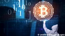 Back view of young hacker pointing at glowing bitcoin sign on blurry city background. with binary code. Web safety and cryptocurrency concept. Double exposure
