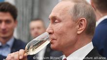 6157415 06.02.2020 Russian President Vladimir Putin drinks champagne during a ceremony awarding the Presidential Prize in science and innovation for young scientists at the Kremlin in Moscow, Russia. Maksim Blinov / Sputnik