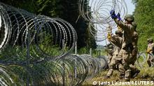 09.07.2021
Lithuanian army soldiers install razor wire on border with Belarus in Druskininkai, Lithuania July 9, 2021. REUTERS/Janis Laizans