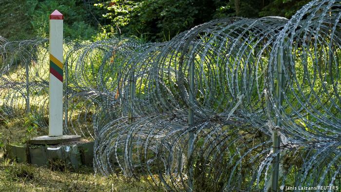 A portion of the razor-wire fence