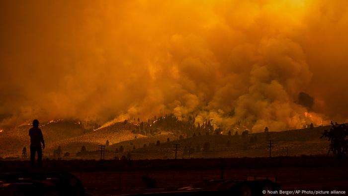 A truck driver watches the Beckwourth Complex Fire