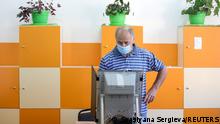 A man votes during a snap parliamentary election, at a polling station in Sofia, Bulgaria, July 11, 2021. REUTERS/Spasiyana Sergieva