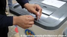 CHISINAU, MOLDOVA - JULY 11, 2021: A local election commission member seals a ballot box at Polling Station 1/71 ahead of the snap parliamentary election. Twenty political parties, 2 electoral blocs and an independent candidate take part in the 2021 Moldovan parliamentary election. Gavriil Grigorov/TASS