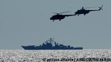 Ukrainian helicopters fly over a Russian warship  during Sea Breeze 2021 maneuvers, in the Black Sea, Friday, July 9, 2021. Ukraine and NATO have conducted Black Sea drills involving dozens of warships in a two-week show of their strong defense ties and capability following a confrontation between Russia's military forces and a British destroyer off Crimea last month. (AP Photo/Efrem Lukatsky)