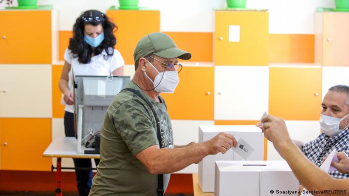 People vote during a snap parliamentary election, at a polling station in Sofia