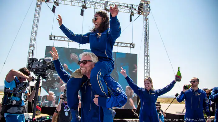 Virgin Galactic's Richard Branson carrying space tourist, aeronautical engineer and Virgin employee Sirisha Bandla on his shoulders