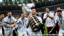 10.07.2021
Soccer Football - Copa America 2021 - Final - Brazil v Argentina - Estadio Maracana, Rio de Janeiro, Brazil - July 10, 2021 Argentina's Lionel Messi and teammates celebrate winning the Copa America with the trophy REUTERS/Amanda Perobelli TPX IMAGES OF THE DAY