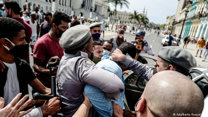 Полицейские задерживают участника протестов на Кубе, 11 июля 2021 года