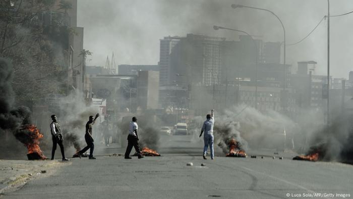 Several shops are damaged and cars burnt in Jeppestown, Johannesburg, following a night of violence. 