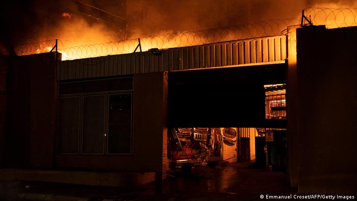 An auto spare parts shop, owned by a migrant, burns during protests in Hillbrow, Johannesburg 