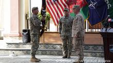 12.07.2021 | U.S. Army Gen. Scott Miller, the top U.S. commander in Afghanistan, left, hands over his command to Marine Gen. Frank McKenzie, the head of U.S. Central Command, right, at a ceremony at Resolute Support headquarters, in Kabul, Afghanistan, Monday, July 12, 2021. The United States is a step closer to ending a 20-year military presence that became known as its “forever war,” as Taliban insurgents continue to gain territory across the country. (AP Photo/Ahmad Seir)