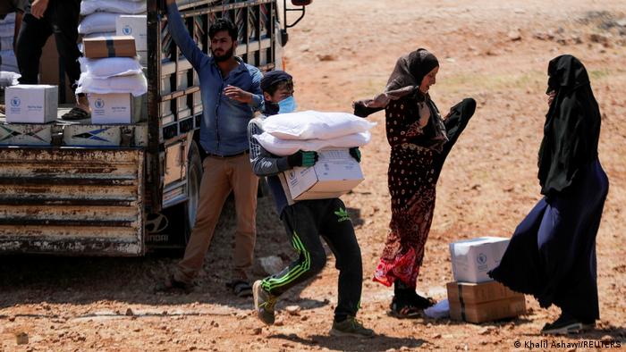 People in the Idlib region getting food aid