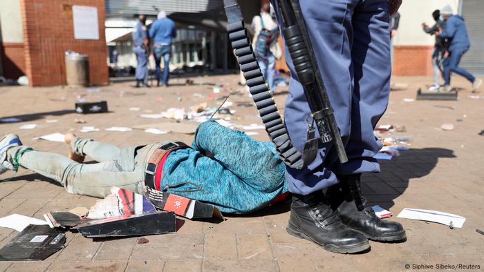 A demonstrator is detained, as protests continue