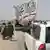 People wave a Taliban flag as they drive through the Pakistani border town of Chaman 