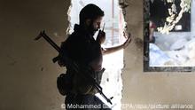 epa05525881 A Jaysh al-Islam fighter (Army of Islam) communicate through a radio with other fighters at Tal al-Siwan area in the rebel-held city of Douma, outskirts of Damascus, Syria, 05 September 2016. Jaysh al-Islam fighters burn tyres, wool, and wood to create smoke clouds in order to blur and disturbe the line of site of snipers and scouts. Jaysh al-Islam, a militia fighting against the Syrian regime, captured Tal al-Siwan from Jaysh al-Tahrir (Liberation Army), a milita alligned with the Syrian regime, on 01 September 2016. EPA/MOHAMMED BADRA ++ +++ dpa-Bildfunk +++