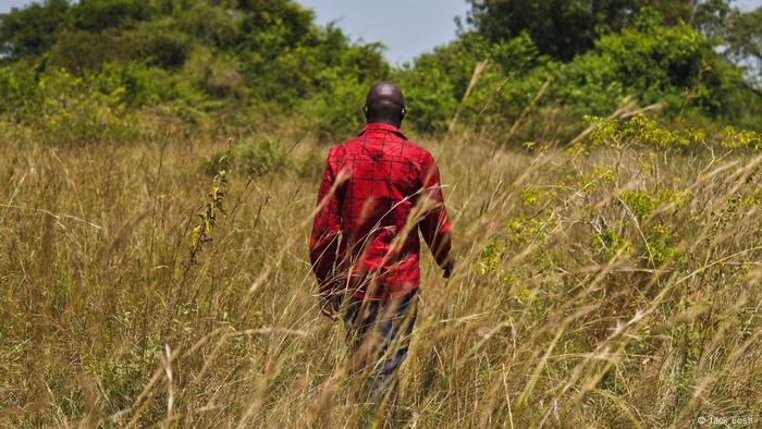 A man walking through tall grass