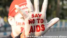 30.11.2018 Kolkata An activist paints his face and hand with HIV/AIDS awareness message during a campaign on the eve of Worlds AIDS Day. World AIDS Day is observed on December 01 every year to raise awareness about HIV/AIDS dedicated to raising awareness of the AIDS caused by the spread of HIV infection and mourning those who have died of the disease. (Photo by Saikat Paul/Pacific Press)