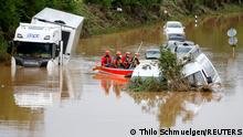Rescue team paddle along flooded cars stuck on the road following heavy rainfalls in Erftstadt, Germany, July 16, 2021. REUTERS/Thilo Schmuelgen