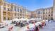People sitting at cafe tables with umbrellas in the inner courtyard of the Humboldt Forum. People sitting at cafe tables with umbrellas in the inner courtyard of the Humboldt Forum.