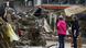 Two people look at debris in the wake of floods in Rhineland-Palatinate, Germany in July 2021 Two people look at debris in the wake of floods in Rhineland-Palatinate, Germany in July 2021