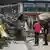 Two people look at debris in the wake of floods in Rhineland-Palatinate, Germany in July 2021