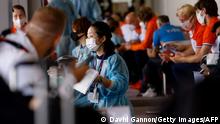 Members of the Netherlands delegation wait for screening and Covid testing upon their arrival on a flight from Amsterdam at Narita International Airport in Narita, Chiba Prefecture on July 18, 2021, ahead of the 2020 Olympic Games in Tokyo. (Photo by David GANNON / AFP) (Photo by DAVID GANNON/AFP via Getty Images)