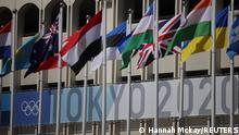 19.07.2021 | Tokyo 2020 Olympics - Tennis Training - Ariake Tennis Park, Tokyo, Japan - July 19, 2021 Tokyo 2020 Olympics signage is seen behind nations flags at the Ariake Tennis Park REUTERS/Hannah Mckay