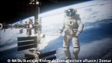 22.05.2021 |International Space Station and astronaut in outer space over the planet Earth. Elements of this image furnished by NASA.