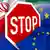 A stop sign on an Iranian and EU flag