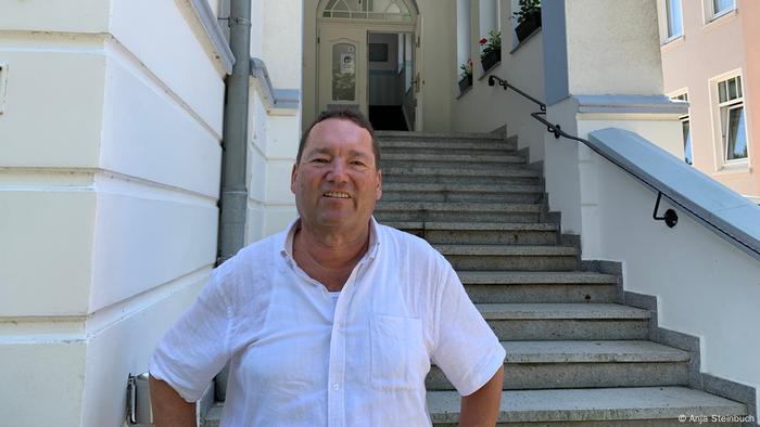 Albrecht Kurbjuhn sits on the stairs of his hotel Albrecht Kurbjuhn sits on the stairs of his hotel