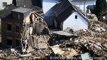 A person walks past destroyed houses in Altenburg, district of Altenahr, Rhineland-Palatinate, western Germany, on July 20, 2021, during clearing work after devastating rains and floods hit the region. (Photo by Christof STACHE / AFP) (Photo by CHRISTOF STACHE/AFP via Getty Images)