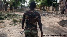 08/12/2016 14:25:24
A nigerian soldier patrols in the streets of Bama in northeast Nigeria on December 8, 2016. - The houses are burnt-out shells, and charred cars and petrol pumps line the roads in the once-bustling Nigerian trade hub of Bama before it was razed by Boko Haram jihadists, know 85% is destroyed. The camp now houses a little over 10,000 people who either escaped or survived the seven months under Boko Haram rule. The conflict with Boko Haram in northeast Nigeria has displaced more than 2.6 million people. (Photo by STEFAN HEUNIS / AFP)