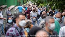 19.07.21 *** Iranian people wearing protective face masks line-up out of a sport hall while waiting to receive a dose of the China's Sinopharm new coronavirus disease (COVID-19) vaccine in central Tehran on July 19, 2021. (Photo by Morteza Nikoubazl/NurPhoto)