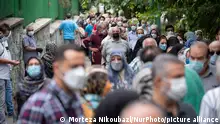 19.07.21 *** Iranian people wearing protective face masks line-up out of a sport hall while waiting to receive a dose of the China's Sinopharm new coronavirus disease (COVID-19) vaccine in central Tehran on July 19, 2021. (Photo by Morteza Nikoubazl/NurPhoto)