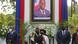 President Moise's wife attends a tribute for her late husband, President Moise, who is seen in a framed picture in the background President Moise's wife attends a tribute for her late husband, President Moise, who is seen in a framed picture in the background