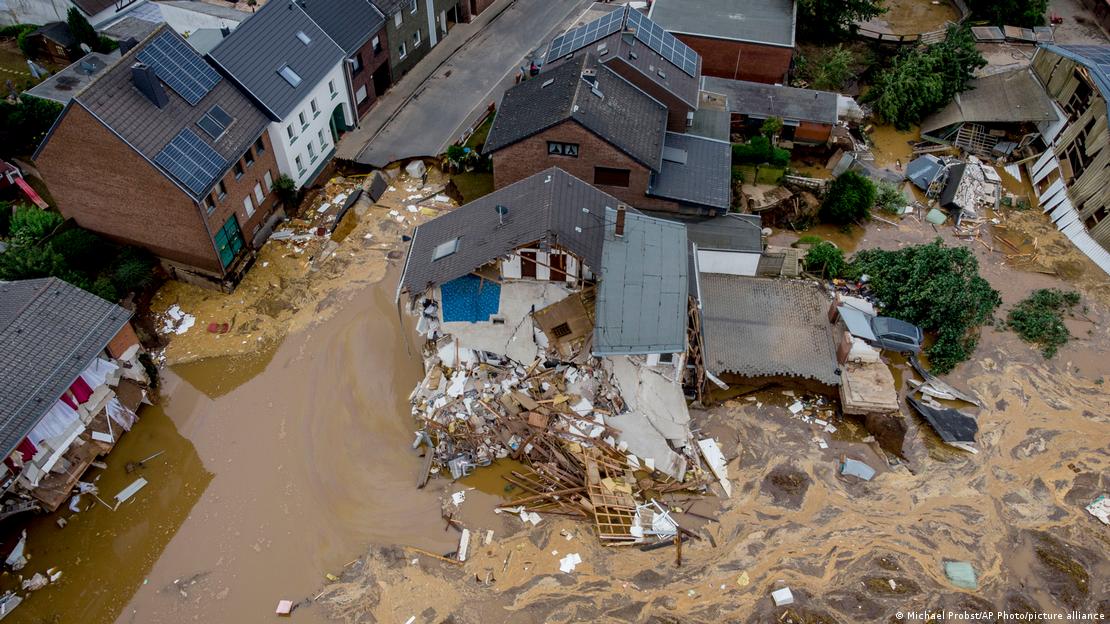 Aerial photo of a destroyed house in Erftstadt surrounded by muddy water
