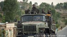 Ethiopian government soldiers ride in the back of a truck on a road leading to Abi Adi, in the Tigray region of northern Ethiopia Tuesday, May 11, 2021. (AP Photo/Ben Curtis)