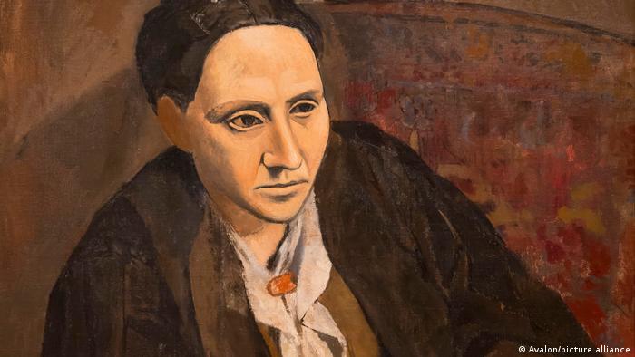 Picture of Gertrude Stein, seated and dressed in dark clothes, painted by Pablo Picasso